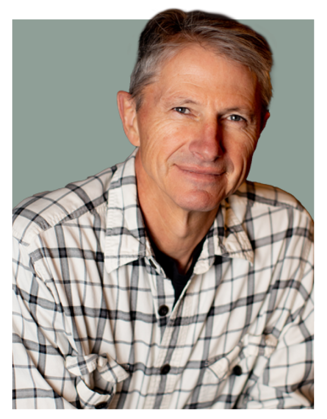 Headshot of Max Winders, author of The Adventures of Mooka & Lou. Max is smiling warmly, wearing a casual flannel button-up shirt. The image is clipped with no background.